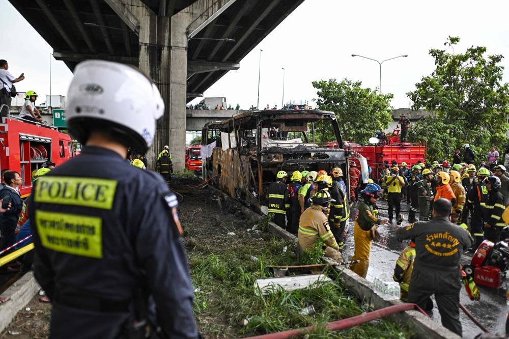 A devastating fire tore through a Thai bus carrying 44 students and teachers on a school trip on Oct 1, with up to 25 feared dead. Photo by Manan Vatsyayana/AFP
