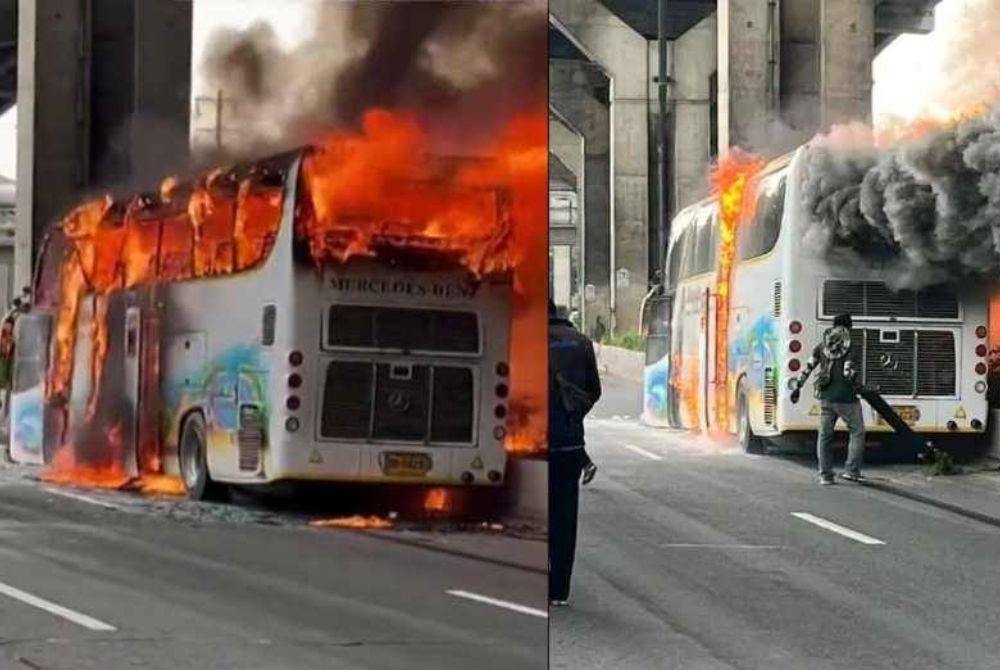 A video of the fire shows flames engulfing the bus under an overpass, with thick black smoke billowing into the sky.