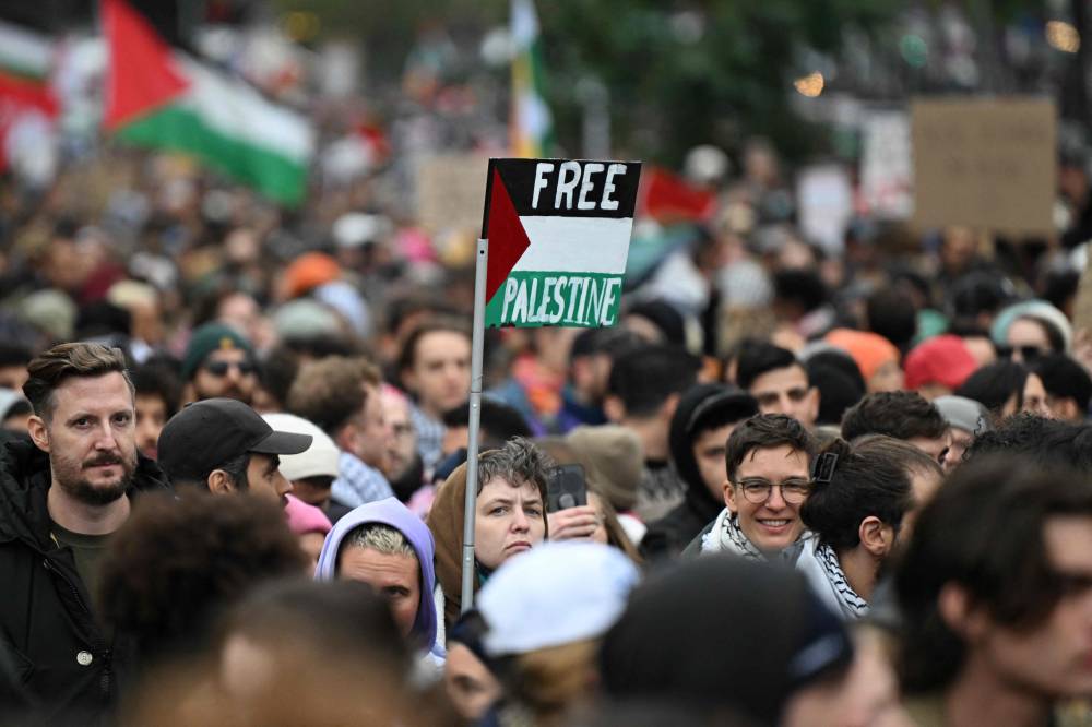 Participants display placards with the lettering 'Free Palestine' as they march during a 'Demonstration against genocide in Gaza' near Kottbusser Tor square in Berlin's Kreuzberg district on Oct 6. Photo by AFP