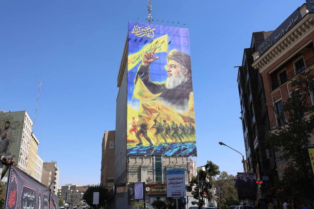 A billboard shows a portrait of slain Lebanese Hezbollah leader Hassan Nasrallah in Tehran on Oct 3. Photo by AFP