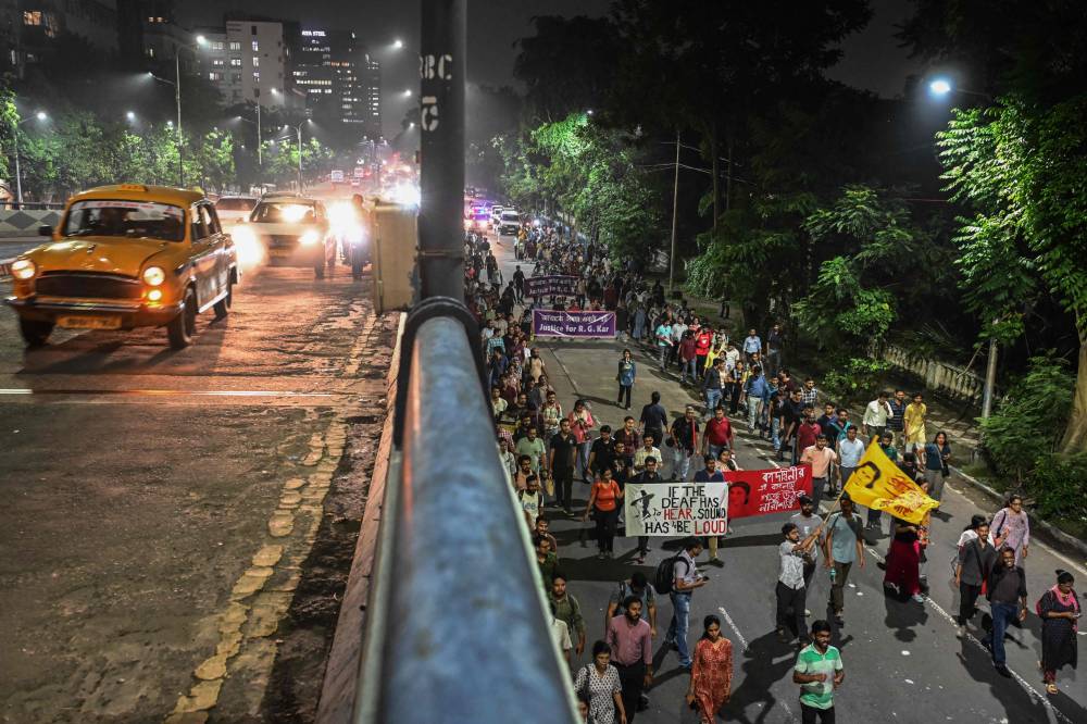 Junior doctors shout slogans as they take part in a protest march to condemn the rape and murder of a doctor, in Kolkata on October 4, 2024. (Photo by AFP)