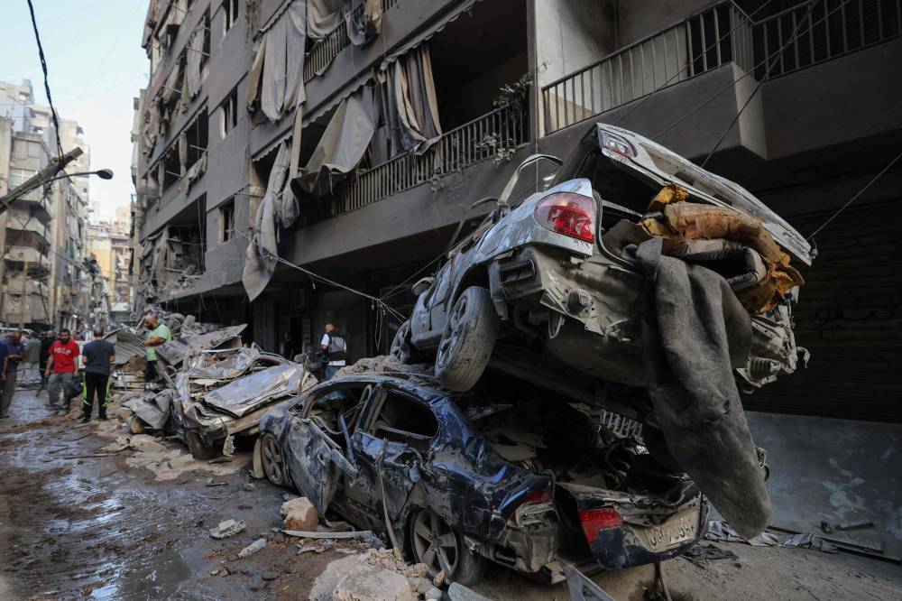 Wrecked cars sit at the site of an Israeli air strike in the Basta area, in Beirut, on October 11, 2024, amid the ongoing war between Israel and Hezbollah. (Photo by ANWAR AMRO / AFP)