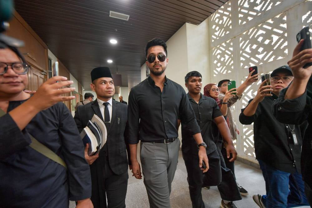 The Federal Territories Syariah High Court today set Feb 20 and Feb 27 next year for the trial of singer Aliff Aziz (middle) and actress Ruhainies who are accused of committing khalwat in March this year. - Photo by Bernama