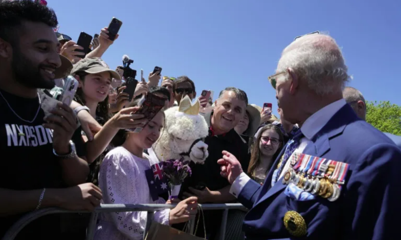 Britain's King Charles III chats with the owner of an alpaca named Hephner before leaving the Australian War Memorial in Canberra on October 21, 2024. Photo by Mark Baker/POOL/AFP