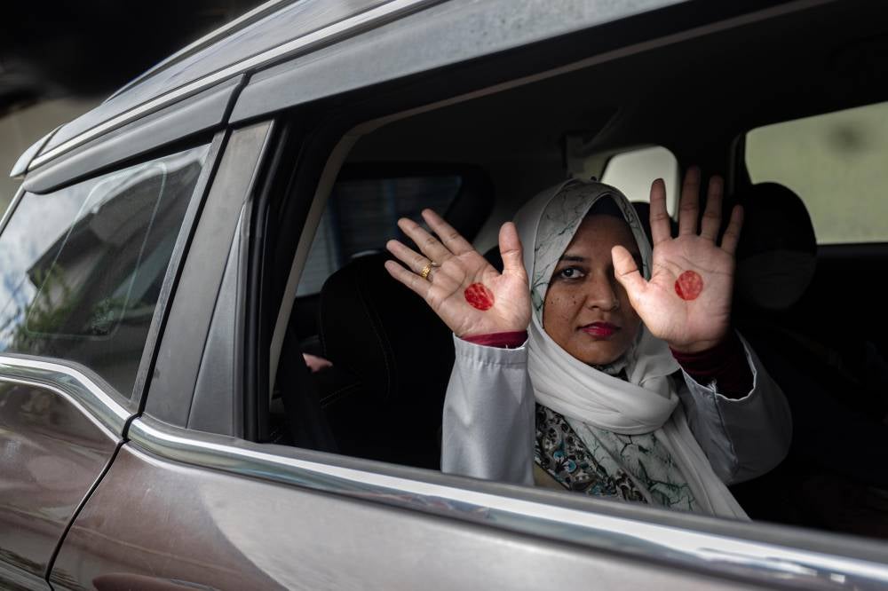 The police took Ummu Atiyah to the alleged location where she was held captive in Batu Hampar, Perak for identification purposes yesterday. Photo by Bernama