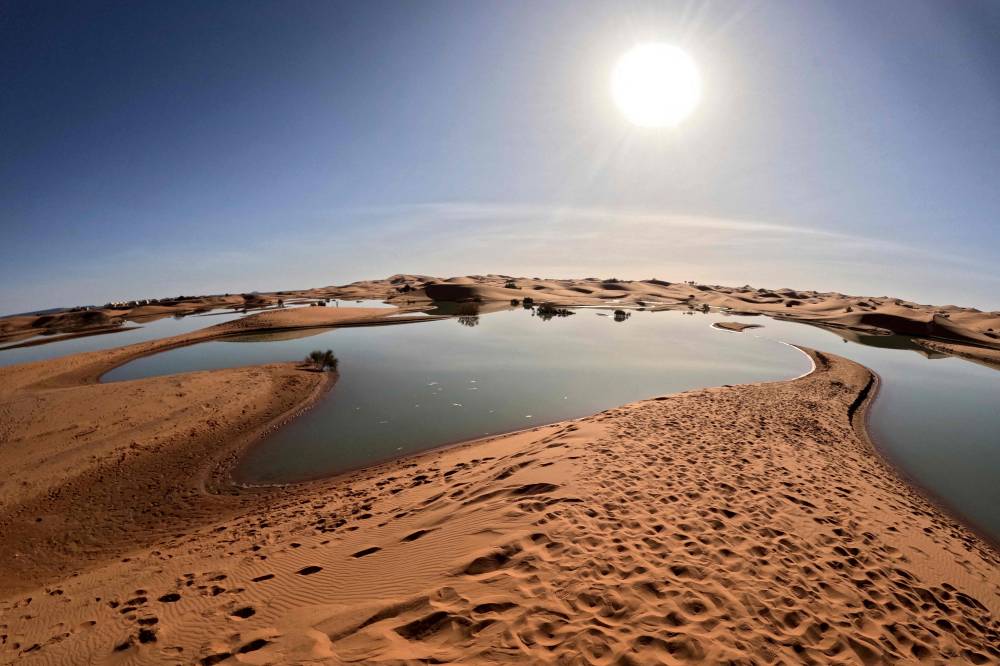 This picture shows a lake Erg Znaigui, a seasonal lake in the village of Merzouga in the Sahara desert in southeastern Morocco on October 20, 2024. - Photo by AFP