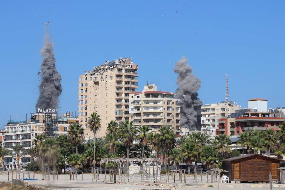 Smoke plumes erupt following an Israeli air strike on a neighbourhood of Lebanon's southern city of Tyre on Oct 23, 2024. - (Photo by KAWNAT HAJU / AFP)
