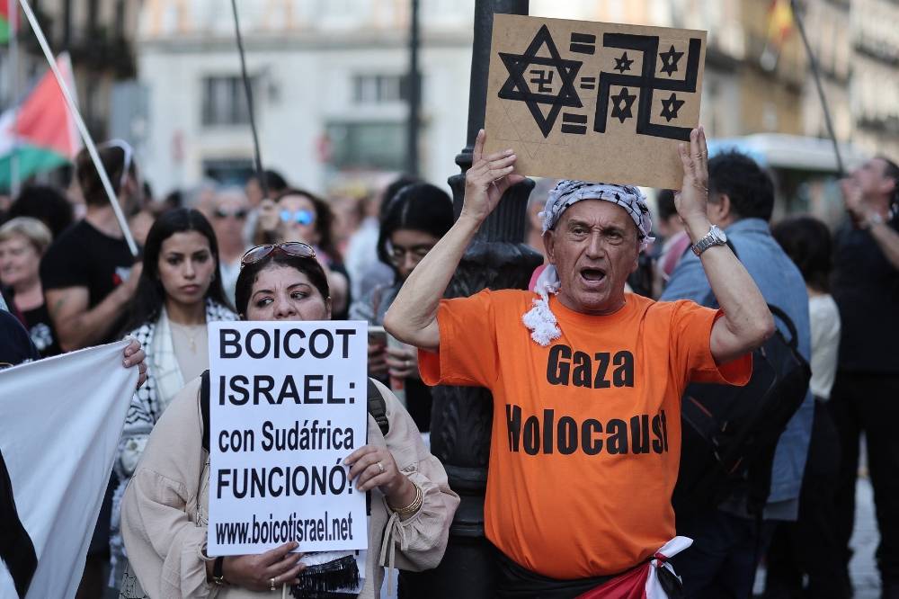 Protestors hold signs reading "Boycott Israel, It worked with South-Africa" as they gather during a pro-Palestinian demonstration, in front of the Foreign Affairs Ministry in Madrid, on May 27. -(Photo by Thomas Coex / AFP)