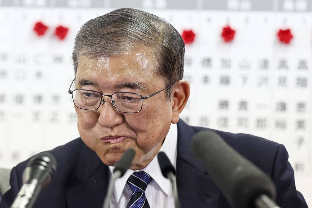 Japan's Prime Minister Shigeru Ishiba reacts during an interview with local media at the Liberal Democratic Party (LDP) headquarters as results in the country's general election are released, in Tokyo. Photo by Jiji Press/AFP