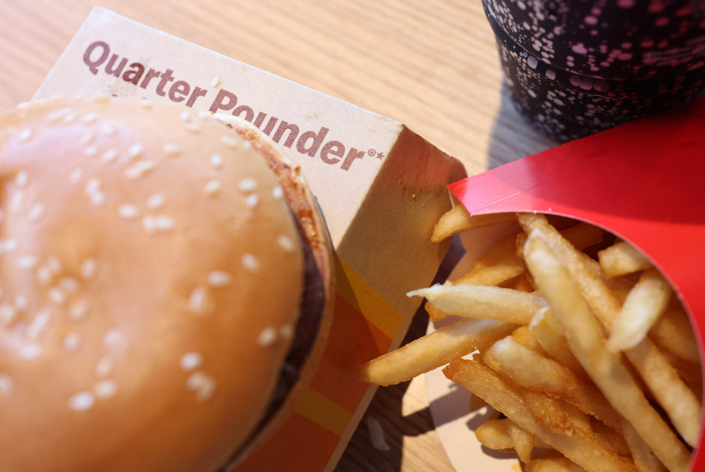 The fast-food giant also issued a statement on Sunday stating that it would start selling its Quarter Pounder hamburgers again after tests for E.coli came back clear. - Photo by AFP