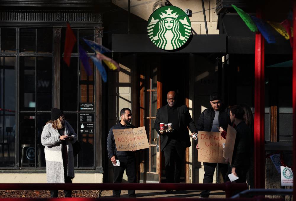 Members and supporters of Starbucks Workers United protest outside of a Starbucks store in Dupont Circle on Nov 16, 2023 in Washington, DC. - (Photo by Kevin Dietsch / AFP)