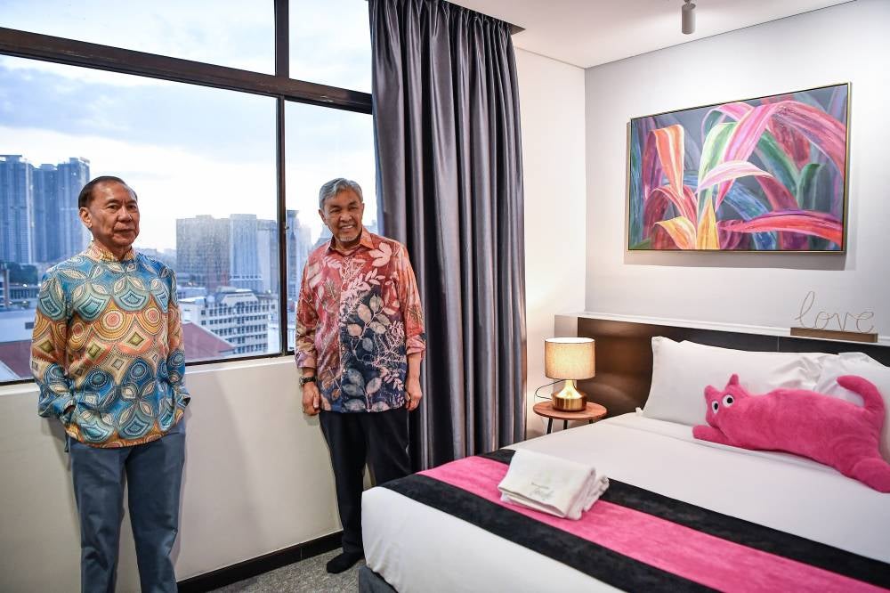Deputy Prime Minister who is also the Rural and Regional Development Minister Datuk Seri Ahmad Zahid Hamidi (right) with Uda Holdings Berhad Chairman Tan Sri Mohd Annuar Zaini (left) visiting Teedo Hotel after its pre-launch ceremony recently. Photo by Bernama