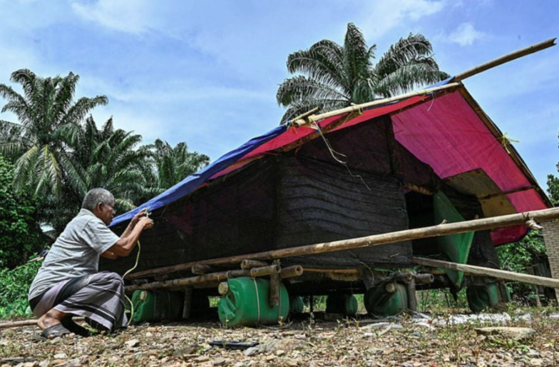 Mohd Sulong from Kampung Pengkalan Ajal, Ajil said his bitter experience of losing thousands of ringgit after his livestock was swept away in flood waters made him, despite his ill health, decide to build a pen on a raft. - Bernama photo