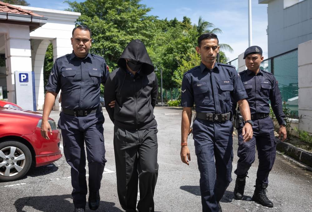 Senior police officer DSP Mohd Nazri Abdul Razak brought to the High Court for causing the death of a student. - Photo by Bernama