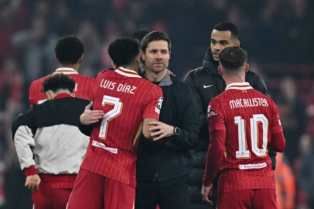 Bayer Leverkusen's Spanish head coach Xabi Alonso (C) congratulates Liverpool's Colombian midfielder Luis Diaz at the end of the UEFA Champions League football match between Liverpool and Bayer Leverkusen at Anfield stadium, in Liverpool, north west England, on November 5, 2024. (Photo by Paul ELLIS / AFP)