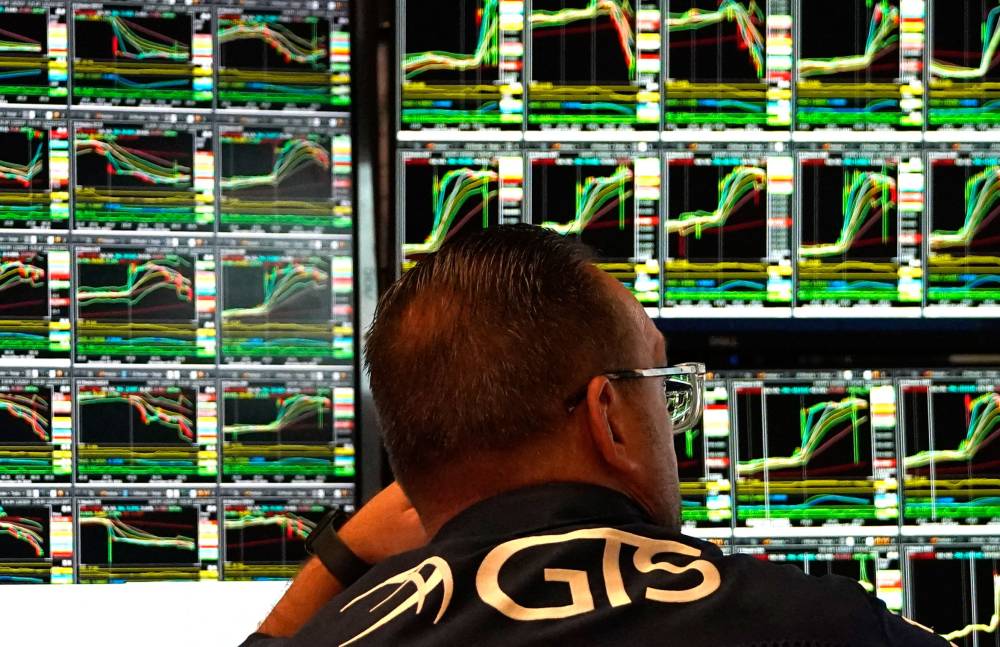 Traders work on the floor of the New York Stock Exchange (NYSE) at the opening bell on November 6, 2024, in New York City. Wall Street stocks surged in opening trading on Wall Street Wednesday after US voters sent Donald Trump back to the White House and delivered him a Republican Senate. Major indices were up 1.8 percent or more in the early going as hopes about expected tax cuts and regulatory easing more than offset worries about higher tariffs. (Photo by TIMOTHY A. CLARY / AFP)