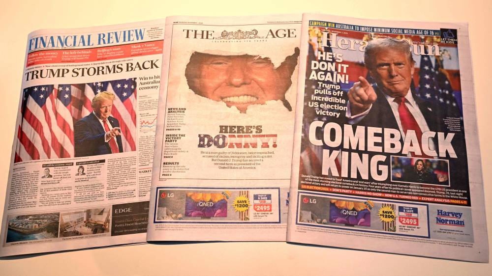 The front pages of the morning newspapers in Melbourne on November 7, 2024, show the reaction to the re-election of US President-elect Donald Trump. US Republican Donald Trump has won the White House, securing more than the 270 electoral votes needed to defeat Democratic Vice President Kamala Harris. (Photo by William WEST / AFP)