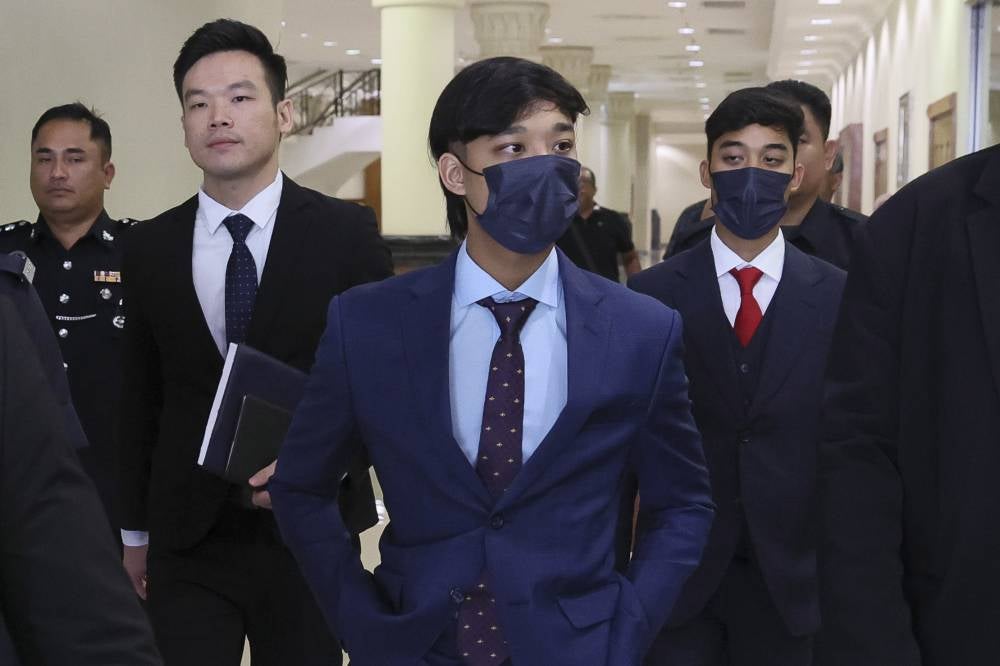 Pahang royalty Tengku Eddie Akasya Tengku Abd Rahman (three, left) with four others pleaded not guilty to a charge of voluntarily causing hurt by dangerous means to a road maintenance worker. - Photo by Bernama