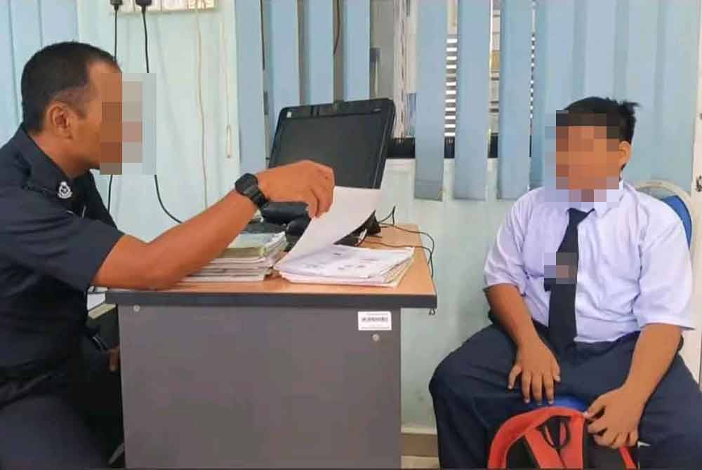 A police officer (left) questioning the boy at the police station.