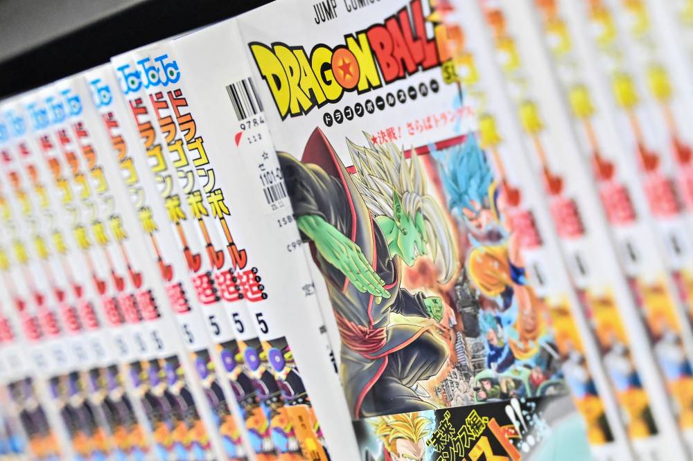 This file photo illustration taken on March 8, 2024, shows books from the popular "Dragon Ball" manga series on a shelf in a store in downtown Tokyo. - (Photo by Richard A. Brooks / AFP)