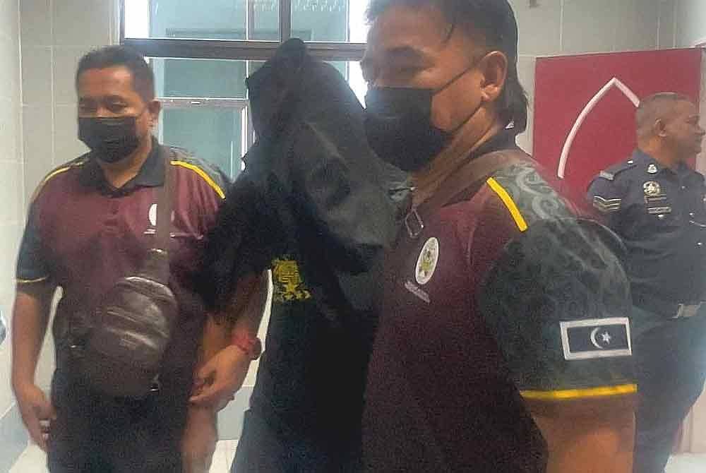 The accused (second from right) was brought to the Terengganu Syariah High Court on Wednesday.