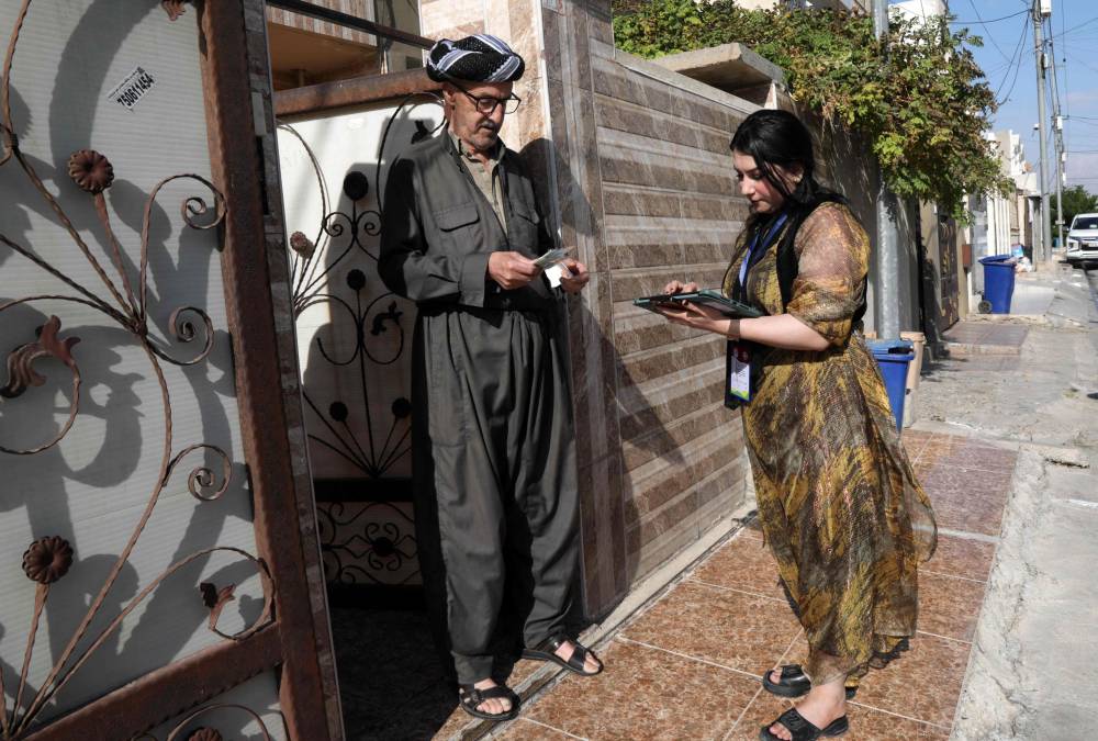 A member (R) of the population and housing department conducts a census in Arbil, the capital of Iraq's autonomous northern Kurdish region, on November 20, 2024, the first nationwide count in Iraq in nearly four decades. The long-awaited count in a nation that has been blighted by sectarian and ethnic divisions is expected to provide sorely needed up-to-date demographic data for the country which has an estimated population of around 44 million. (Photo by Safin HAMID / AFP)