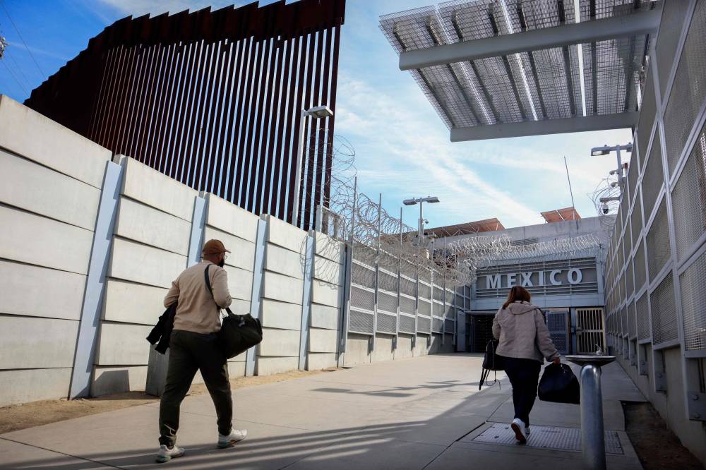 Shoppers head into Mexico in San Ysidro, California, on November 26, 2024. US President-elect Donald Trump threatened to begin his presidency with a massive trade war -- and diplomatic crisis -- as he demanded China, Canada and Mexico stop illegal immigration and drug smuggling into the United States or face punitive US import tariffs. (Photo by Sandy Huffaker / AFP)