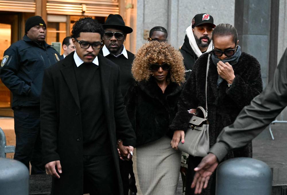 Sean "Diddy" Combs' mother Janice Combs (C) holds her grandson's Justin Dior Combs' hand (L) as they leave the federal court after Sean "Diddy" Combs' bail hearing on November 22, 2024 in New York City. (Photo by TIMOTHY A. CLARY / AFP)