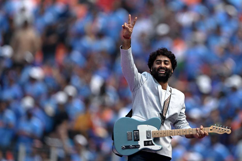 Indian playback singer Arijit Singh performs before the start of the 2023 ICC Men's Cricket World Cup one-day international (ODI) match between India and Pakistan at the Narendra Modi Stadium in Ahmedabad on October 14, 2023. (Photo by Punit PARANJPE / AFP) / -- IMAGE RESTRICTED TO EDITORIAL USE - STRICTLY NO COMMERCIAL USE --