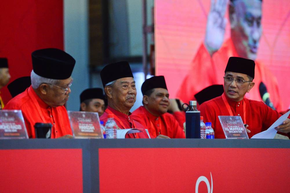 (From left) Bersatu deputy president Datuk Seri Hamzah Zainudin, president Tan Sri Muhyiddin Yassin and secretary-general Datuk Seri Mohamed Azmin Ali at the party's Annual General Assembly held at the Ideal Convention Centre, Shah Alam, today. - Photo by ASRIL ASWANDI SHUKOR
