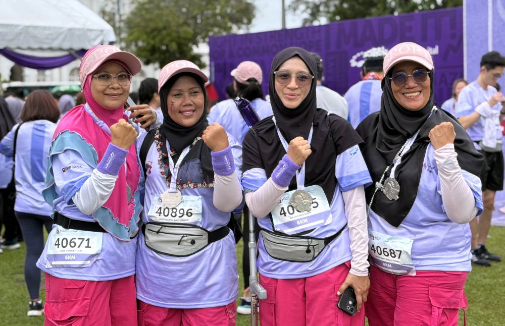 Breast cancer fighter Haliza Abd Halim (right) with her friends while participating in the Warrior Run 2024 at Esplanade Padang Kota yesterday. Photo by Bernama