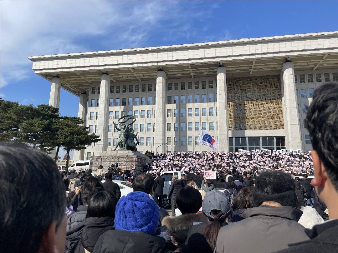 People, gathered in front of the National Assembly Building, protest following the declaration of martial law in Seoul, South Korea. Photo by Anadolu.