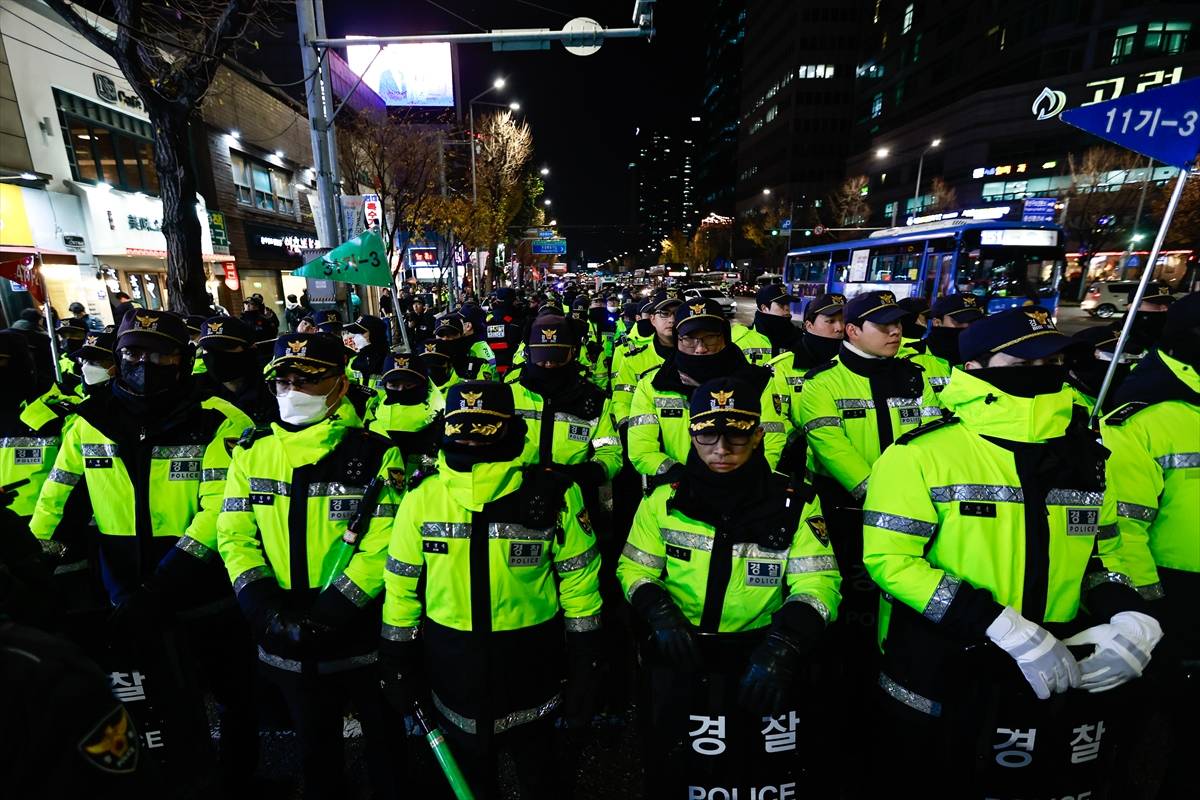 Police officers stand guard as people march to protest against South Korean president Yoon Suk Yeol, in Seoul, South Korea, on December 5, 2024. - Photo by Anadolu Agency