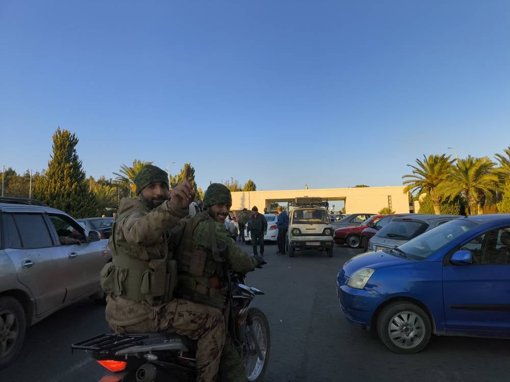 Members of armed groups are seen in the garden of the empty Presidential Palace after sixty-one years of Baath Party rule in Syria collapses on Sunday when, the capital fell out of the hands of regime control in Damascus, Syria on December 08, 2024. (Photo by Abdülkerim Muhammed-Anadolu Agency )
