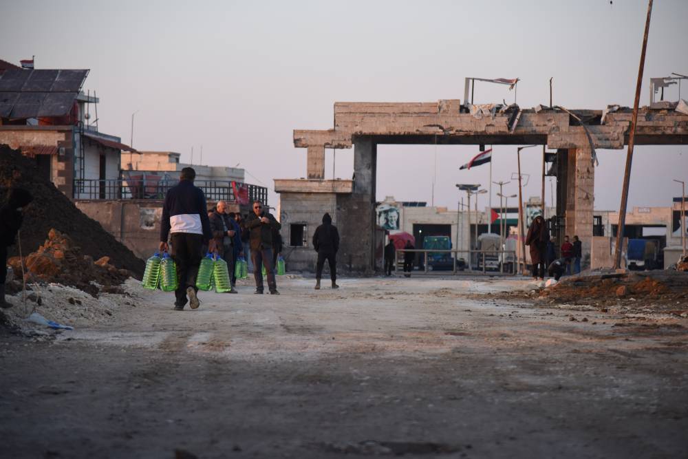 People walk near the reopened Al-Arida border crossing connecting Lebanon and Syria on Nov 30, 2024. - File photo by Khaled Habashiti/XINHUA