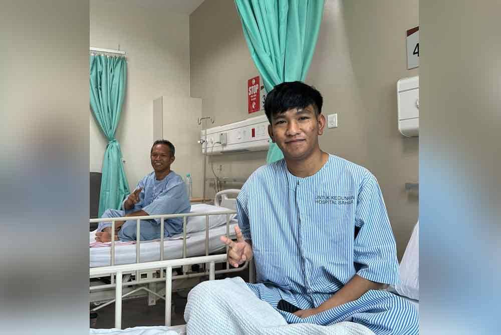 Muhamad Firdaus (right) with his father, Rosly Delniah (left).