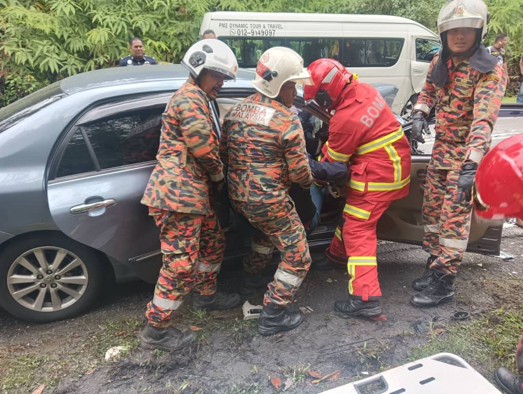 Firemen removing a victim from the wrecked vehicle. Photo courtesy of Fire and Rescue Department.