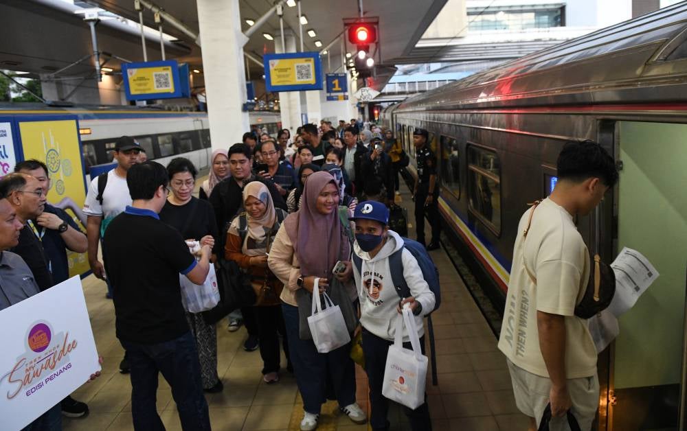 Passengers excited to use the MySawasdee Penang Edition special train service during the first day of its trial service from the Butterworth-Hai Yai, Thailand-Butterworth station on Dec 29, 2024. - Photo by Bernama