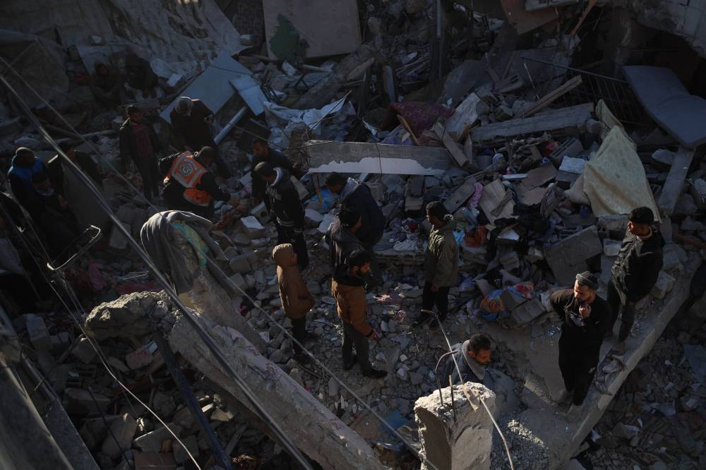 Palestinians are seen at the site of a destroyed house after an Israeli bombardment, in the Maghazi camp, central Gaza Strip, on Dec. 28, 2024. - (Photo by Marwan Dawood / XINHUA)