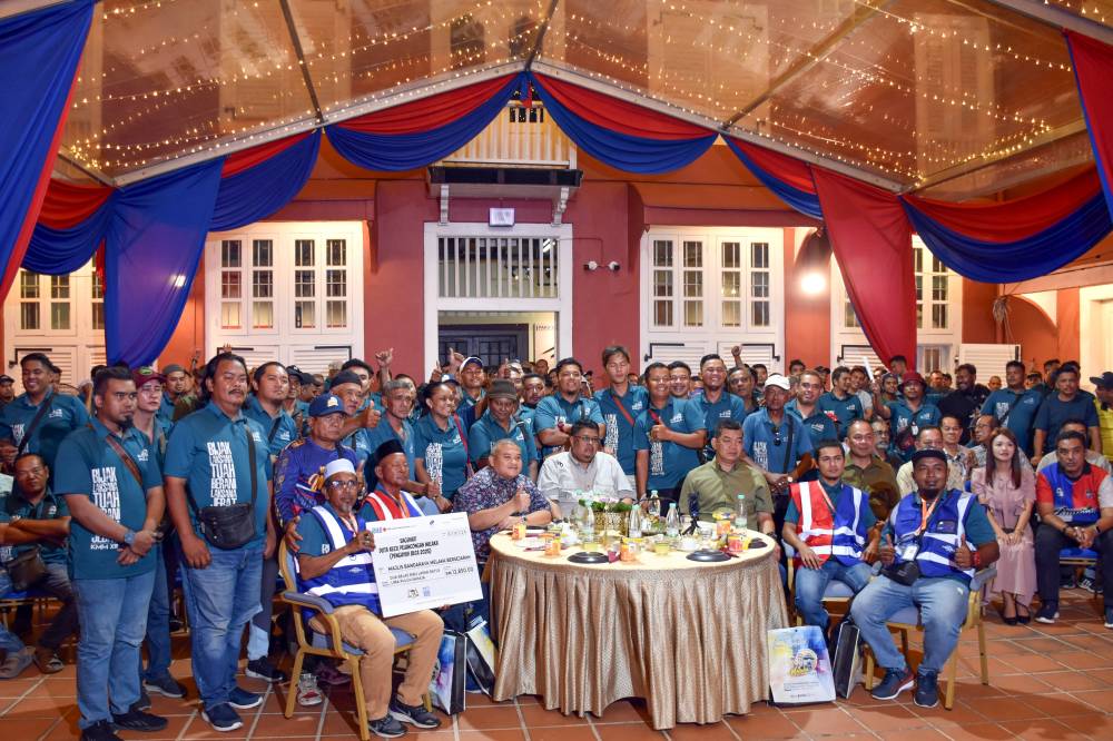 Melaka Chief Minister Datuk Seri Ab Rauf Yusoh (seated, centre) poses with some of the trishaw riders who serve as Tourism Ambassadors for the state during the Melaka Trishaw Riders Appreciation Ceremony 2025 held on Jan 2. - Photo by Bernama