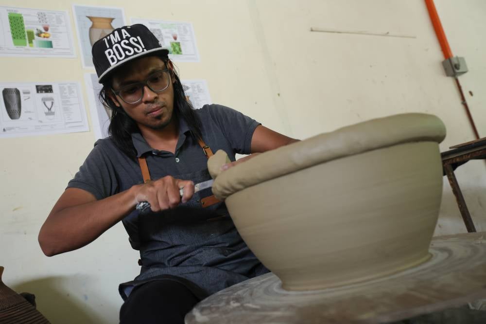 Muhammad Luqman NulHakim Mohd Sa'ya demonstrates the process of creating clay-based products at the Perak Malaysian Handicraft Development Corporation. - Photo by Bernama