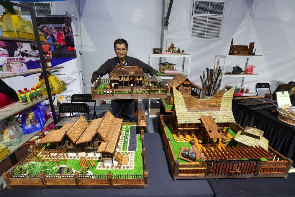 A craft entrepreneur specialising in traditional Malay house replicas, Mohd Amin Afuan, 58, showcases a replica of a Johor house during an interview with Bernama at the Johor Craft Festival and the 2024 Kota Selatan Festival at Angsana Johor Bahru. - Photo by Bernama