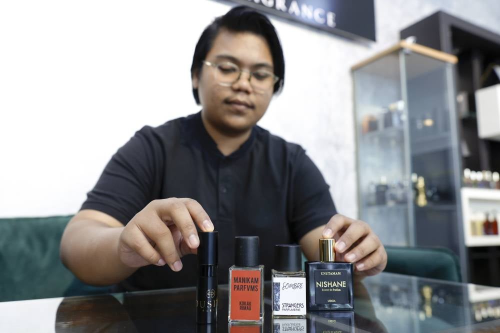Muhamad Lukman Nur Hakim Rosmizan, 24, showing his favourite scents. - Photo by Bernama