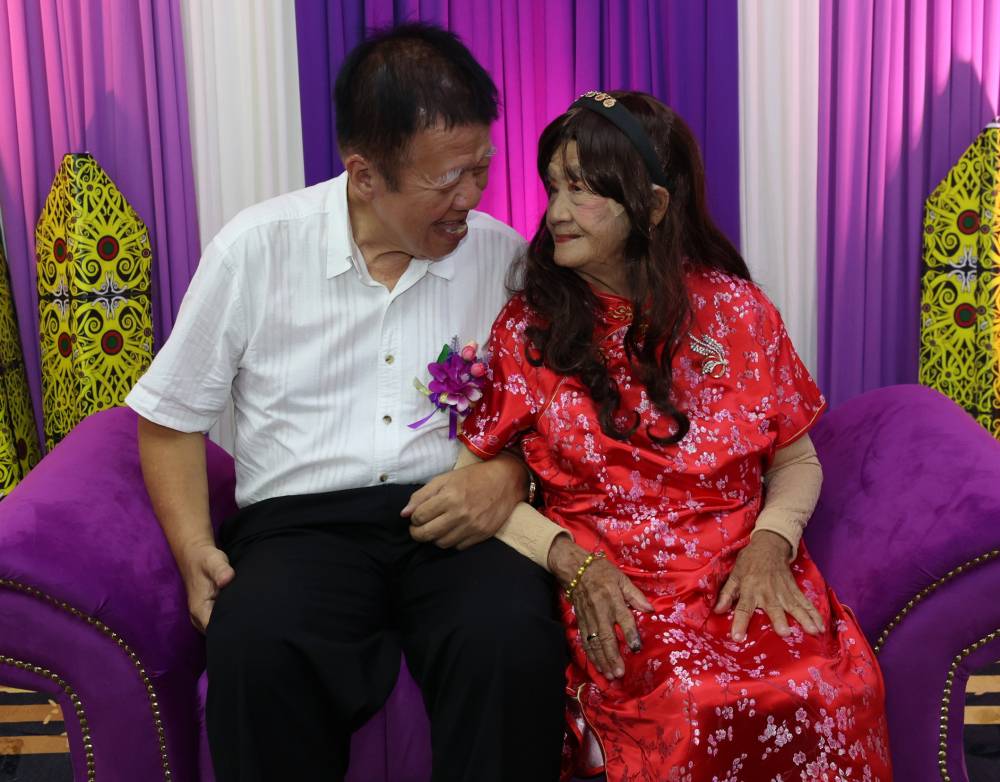 Teo's (right) meeting with Richard at Rumah Seri Kenangan Kuching eventually blossomed into love, as their complementary personalities made them a perfect match. Photo by Bernama