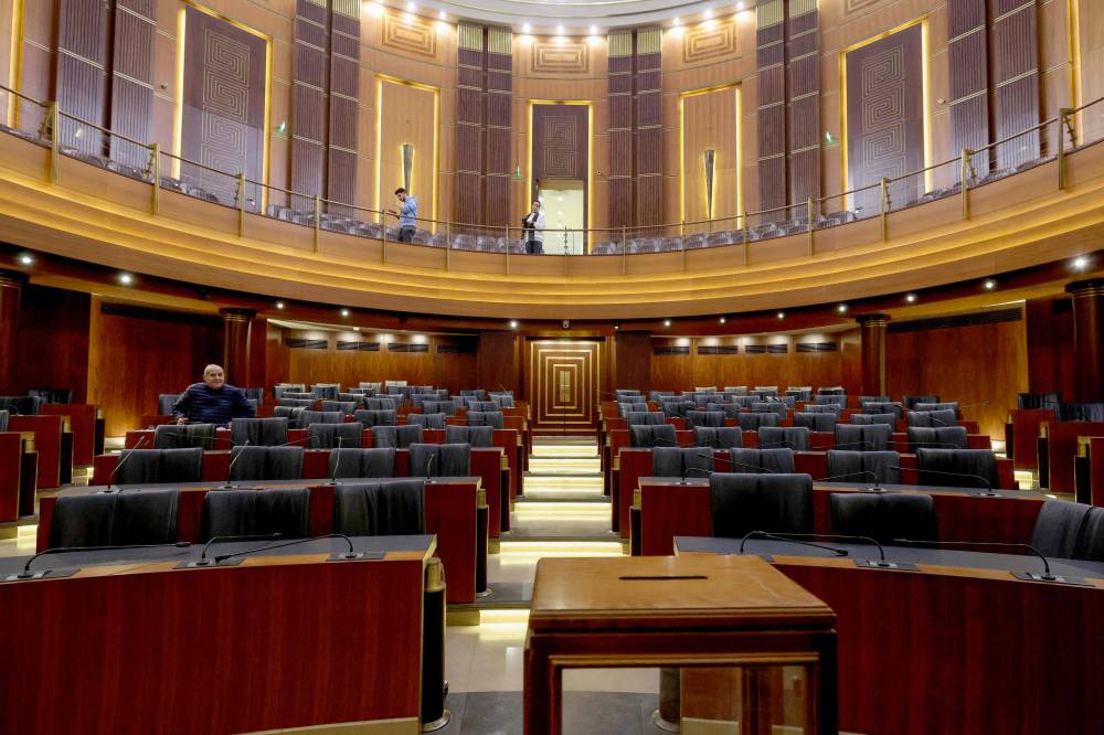 Members of staff prepare the main chamber of the Parliament and set up a ballot box, a day ahead of a parliamentary session to elect a president in Beirut on January 8, 2025. - Photo by AFP