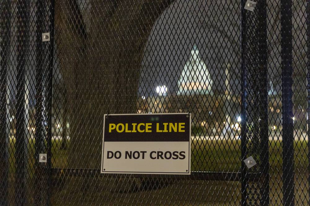This photo taken on Jan. 5, 2025 shows the U.S. Capitol building seen through a security fence in Washington, DC, the United States. (Photo by Xinhua/Hu Yousong)