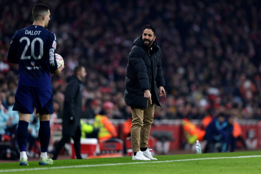 Manchester United's Portuguese head coach Ruben Amorim (R) shouts at Manchester United's Portuguese defender Diogo Dalot as he prepares to take a throw-in during the English FA Cup third round football match between Arsenal and Manchester United at the Emirates Stadium in London on January 12, 2025. (Photo by Ian Kington/AFP)