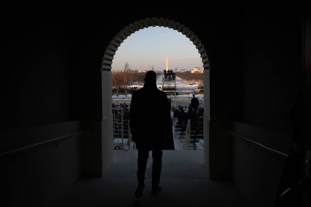 A stand-in for US President-elect Donald Trump, US Army Master Sergeant Matthew Nall, walks on stage during a rehearsal at the US Capitol for the presidential inauguration January 12, 2025 in Washington, DC. US President-elect Donald Trump will be sworn into office in eight days on January 20, 2025. - Photo by AFP