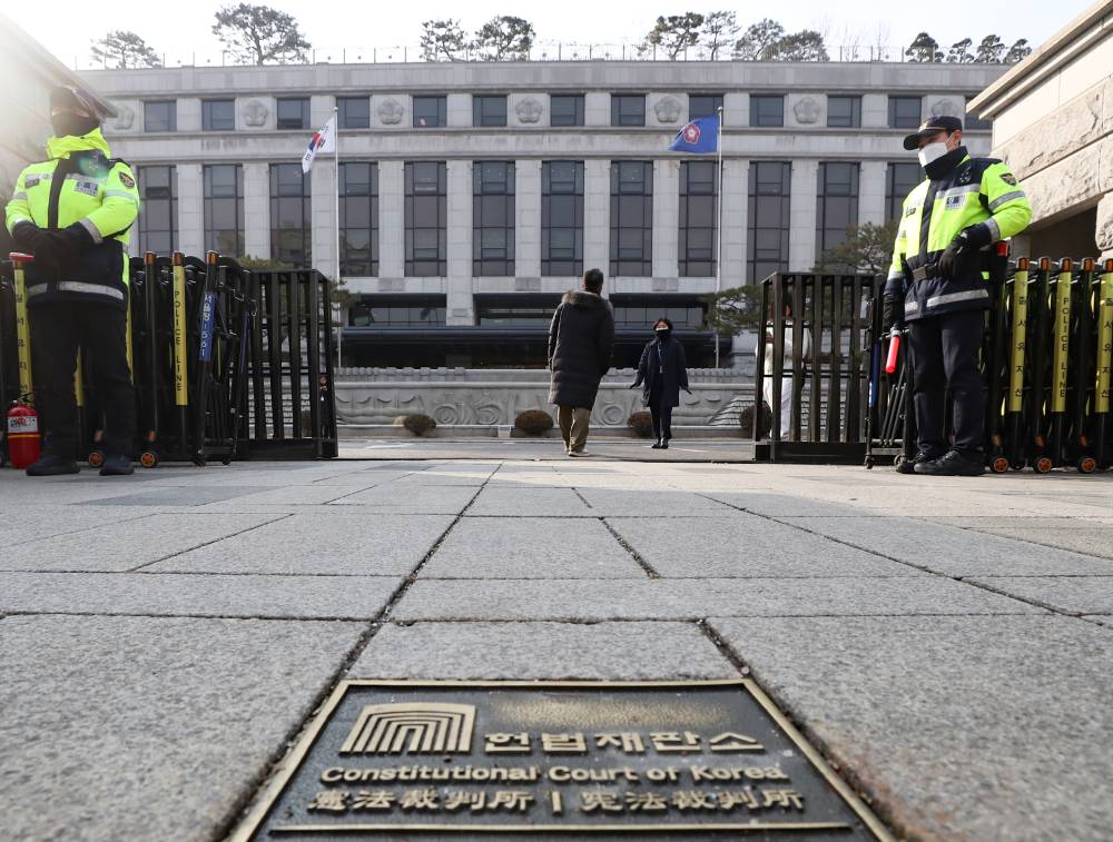Police officers stand guard in front of the South Korean constitutional court in Seoul, South Korea. (Photo by Xinhua/Yao Qilin)