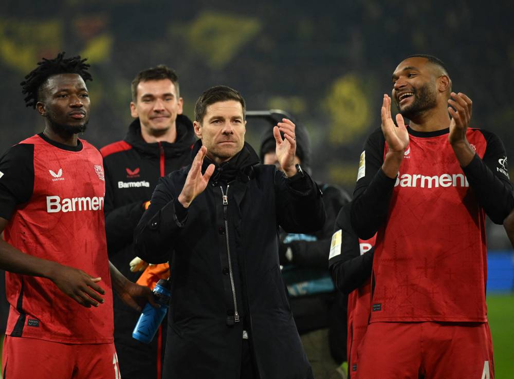 Bayer Leverkusen's Spanish head coach Xabi Alonso (C) reacts after the German first division Bundesliga football match between Borussia Dortmund and Bayer 04 Leverkusen in Dortmund, western Germany, on January 10, 2025. (Photo by INA FASSBENDER/AFP)